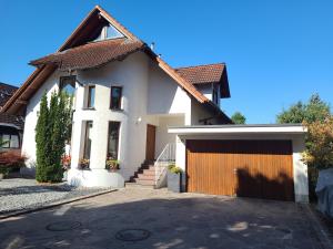 a white house with a garage and a driveway at Bühler Blick in Bühl