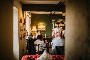 a group of people sitting in a room at The Brackenrigg Inn in Watermillock