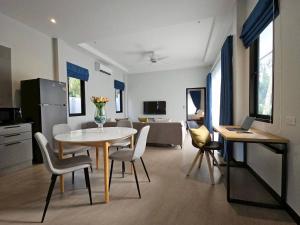 a kitchen and living room with a table and chairs at The white mountain pool villa Ao Nang in Ban Thai Thai