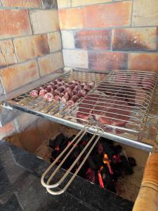 a rack of meat cooking on a grill at Espaço Recanto Del Mar in Paracuru
