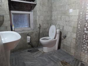 a bathroom with a toilet and a sink at Nalze Khar in Raogi +20 photos
