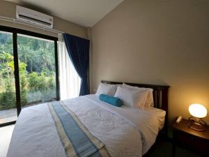 a bedroom with a bed with a large window at The white mountain pool villa Ao Nang in Ban Thai Thai +100 photos