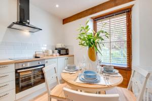 a kitchen with a wooden table with a plant on it at 2 Bed in Lynton oc-lyncha in Lynmouth
