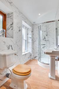 a white bathroom with a toilet and a sink at 2 Bed in Lynton oc-lyncha in Lynmouth +14 photos