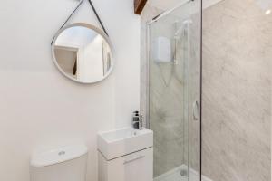 a bathroom with a mirror and a toilet and a shower at 3 Bed in Yeolmbridge oc-t30293 in Werrington +26 photos