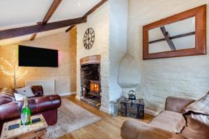 a living room with a couch and a fireplace at 3 Bed in Yeolmbridge oc-t30293 in Werrington