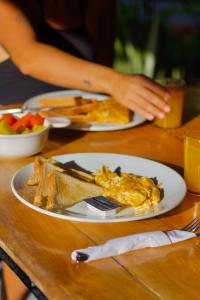 two plates of breakfast food on a table at Hotel Sol y Mar in Santa Catalina