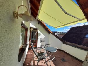 a patio with a table and chairs on a balcony at Bühler Blick in Bühl