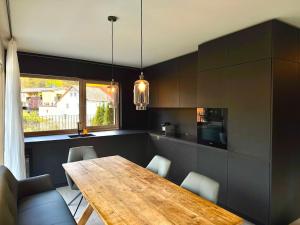a kitchen with a wooden table and some chairs at Z-Apartment Parkgasse in Schladming
