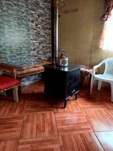 a tea kettle on top of a table in a room at Cabañas Jade in Cochamó +7 photos