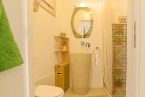 a bathroom with a shower and a toilet and a mirror at CAMASUD 3 L'ATTICO Nardò in Nardò +11 photos