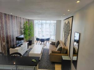 a living room with a couch and a table at 2 BEDROOM Condo -IPANEMA in Rio de Janeiro