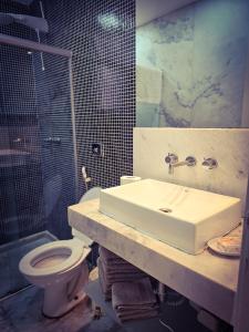 a bathroom with a sink and a toilet at 2 BEDROOM Condo -IPANEMA in Rio de Janeiro +16 photos