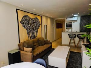 a living room with a couch and a kitchen at 2 BEDROOM Condo -IPANEMA in Rio de Janeiro