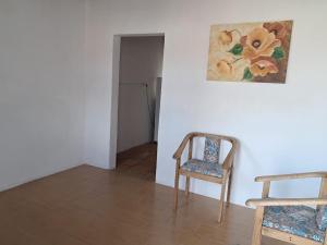 a room with a chair and a painting on the wall at Casa Aconchego in São Gabriel