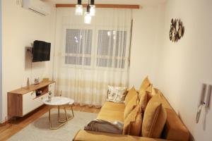 a living room with a couch and a window at Apartman Wish Lux in Vrnjci