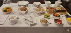 a table topped with bowls of different types of food at Come As You Are Inn LLC in Sayville