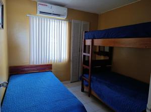 a bedroom with two bunk beds and a window at Apartamento playa Tonsupa in Tonsupa +12 photos