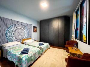 a hotel room with two beds and a table at Dimora Marisa in Albiate