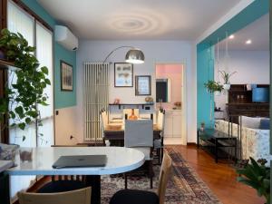 a living room with a table with a laptop on it at Dimora Marisa in Albiate