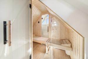a wooden staircase in a house with a window at Mare in Hörnum