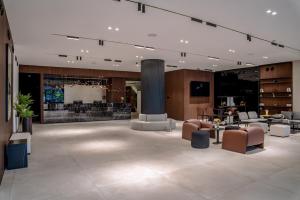 a large room with a lobby with chairs and tables at The Pelican Hotel Cantonments Accra in Accra