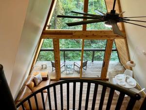 a view of a room with a ceiling fan at Black Gum Getaway-Cozy Forest A-frame Near Bentonville in Rogers