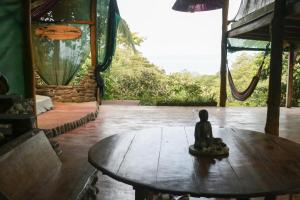 a small statue sitting on a table in a room at Open spacious house with stunning Peninsula view in Pavones
