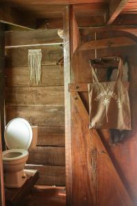 a bathroom with a toilet and a paper bag at Open spacious house with stunning Peninsula view in Pavones +63 photos