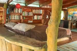 a bedroom with a bed in a log cabin at Open spacious house with stunning Peninsula view in Pavones