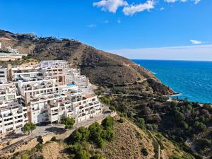 an aerial view of a building on a hill next to the ocean at Sea&Skyline Suites Benidorm in Benidorm