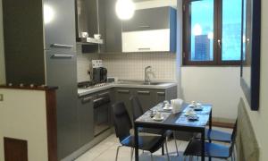 a small kitchen with a table and a table and chairs at casa vacanze crochi in Viterbo