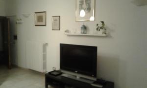 a living room with a flat screen tv on a wall at casa vacanze crochi in Viterbo