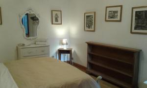 a bedroom with a bed and a dresser and a mirror at casa vacanze crochi in Viterbo