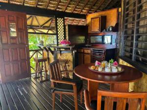 a kitchen with a table and chairs in a room at Fare PEA ITI Romantic Lodge in Patio