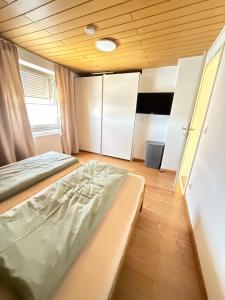 a bedroom with two beds and white cabinets at Ferienwohnung Haus Grenzwald in Nettetal