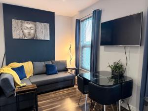a living room with a couch and a table at Harvey Apartments in Derry Londonderry