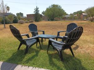 three chairs and a table in the grass at Casa en Ataliva Roca in Ataliva Roca