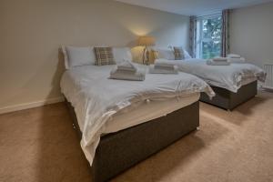 two twin beds in a bedroom with a window at The Fairways House in Glenrothes +124 photos