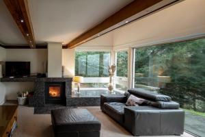 a living room with a couch and a fireplace at The Fairways House in Glenrothes