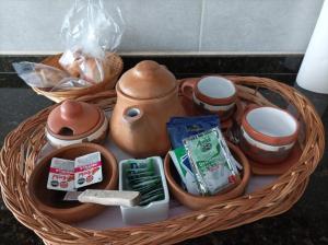 a wicker basket with pots and other items in it at Casa en Ataliva Roca in Ataliva Roca +4 photos