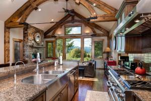 a kitchen with a large sink and a large window at Abode at Teton Manor in Jackson