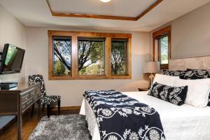 a bedroom with a bed and a desk and window at Abode at Teton Manor in Jackson