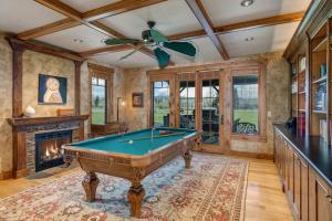 a pool table in a room with a fireplace at Abode at Open Meadows in Wilson