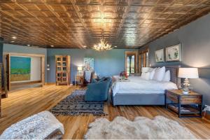 a bedroom with a large bed and a wooden ceiling at Abode at Open Meadows in Wilson