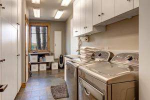 a laundry room with a washer and dryer at Abode at Open Meadows in Wilson +55 photos