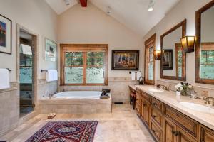 a large bathroom with a tub and two sinks at Abode at Two Wolves in Teton Village +70 photos