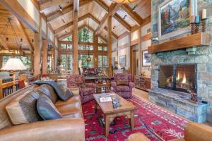 a living room with a couch and a fireplace at Abode at Two Wolves in Teton Village