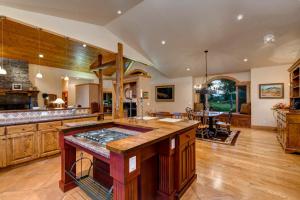 a large kitchen with wooden cabinets and a large island at Abode at Sweetwater in Wilson