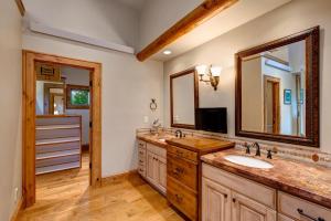 a bathroom with a sink and a large mirror at Abode at Sweetwater in Wilson +40 photos
